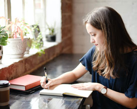 Woman writing in journal